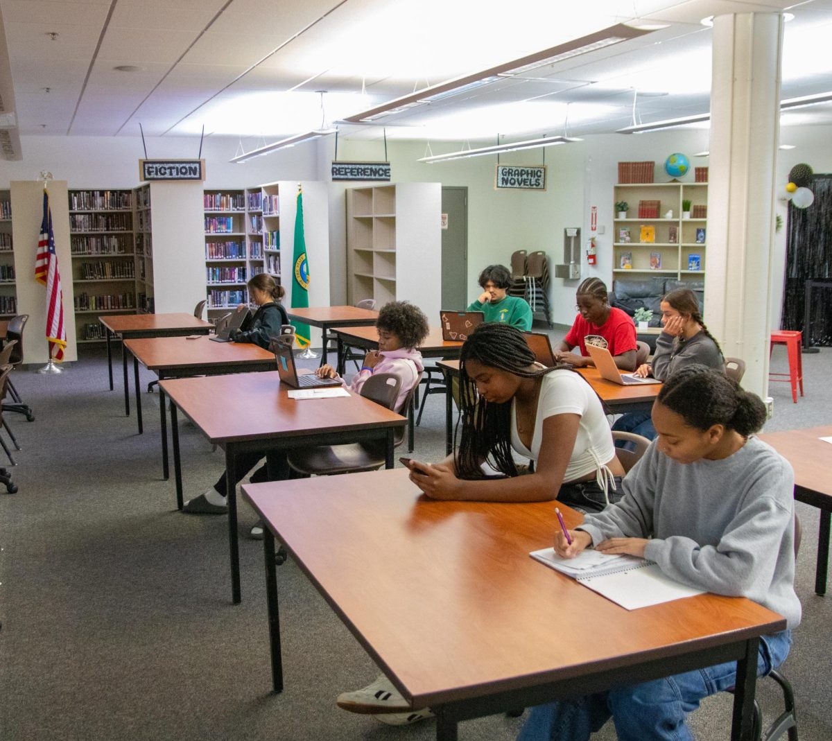 Amaya Jordan, Marquis Bean, Jaylynn Dobbs, Mya Clardy, Evoleno Oledan, Malemo Kavinguha and Dori Emmons study in the SHS library between their in-person Running Start classes at Pierce College. Several Running Start students use the library for their virtual courses as well.