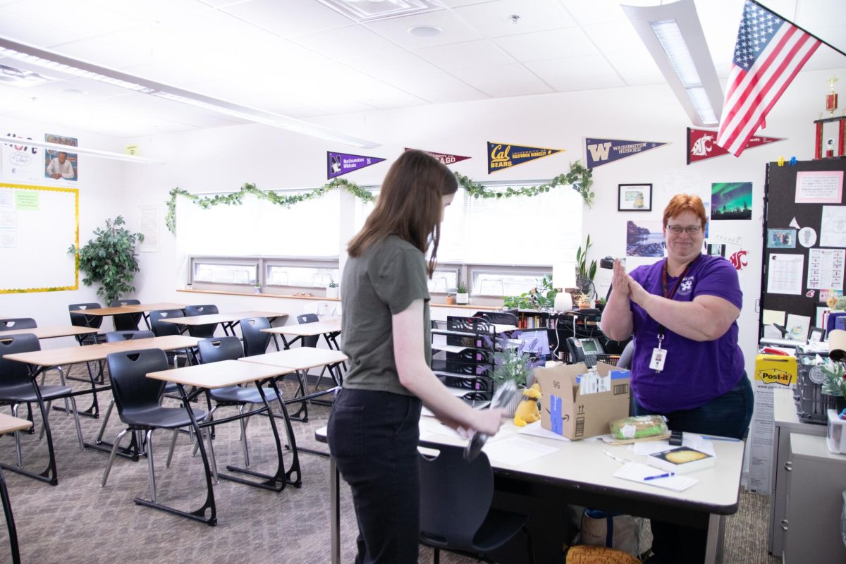 Literature Club adviser and AP Literature teacher, Renee Chase, congratulates first place prize winner, SHS senior Noelle Reger, for her short fiction story about the implications of AI set in the not-so-distant future. Senior Makenzie Barber’s poem, “Danced at Dawn,” placed first for poetry. All pieces were judged blindly by a panel of SHS staff.