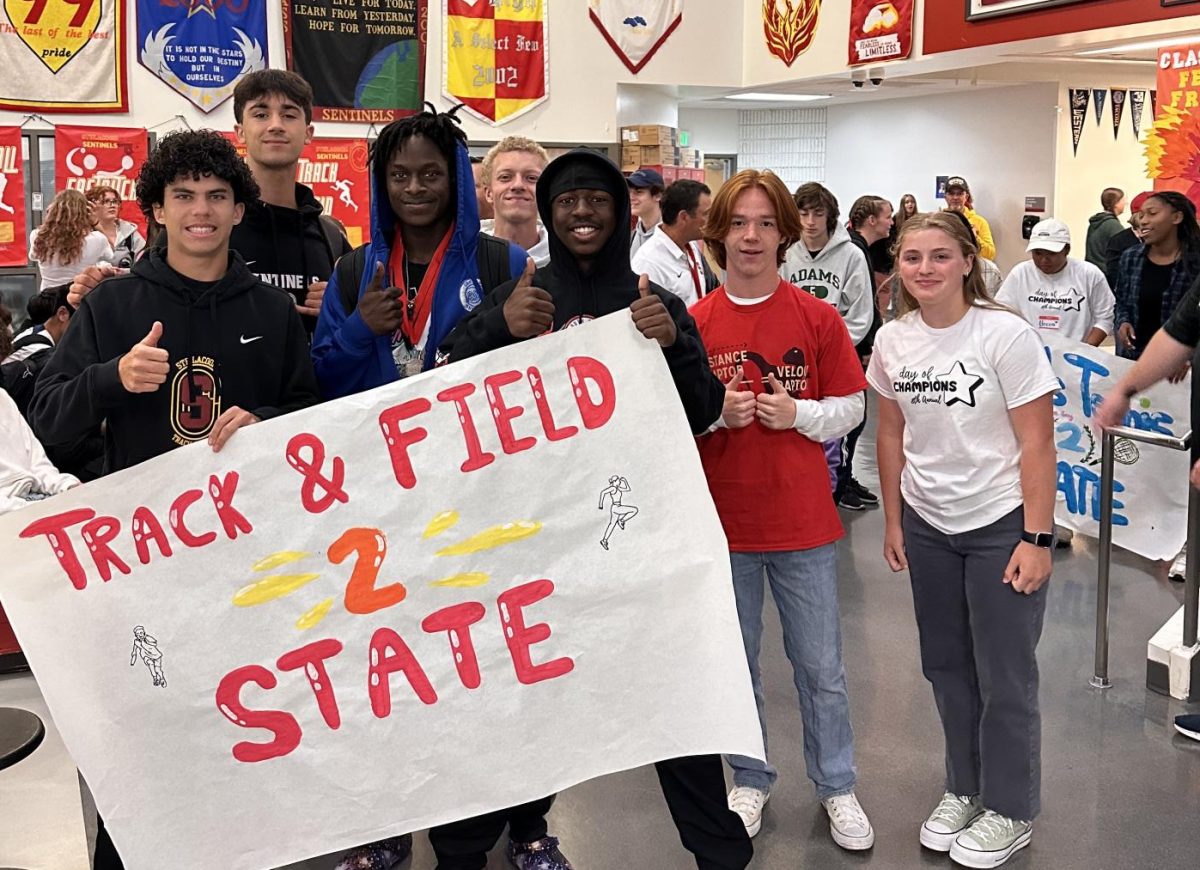 Track and Field are celebrated during the morning State parade surrounded by their coaches, the student body and the SHS band playing in celebration.