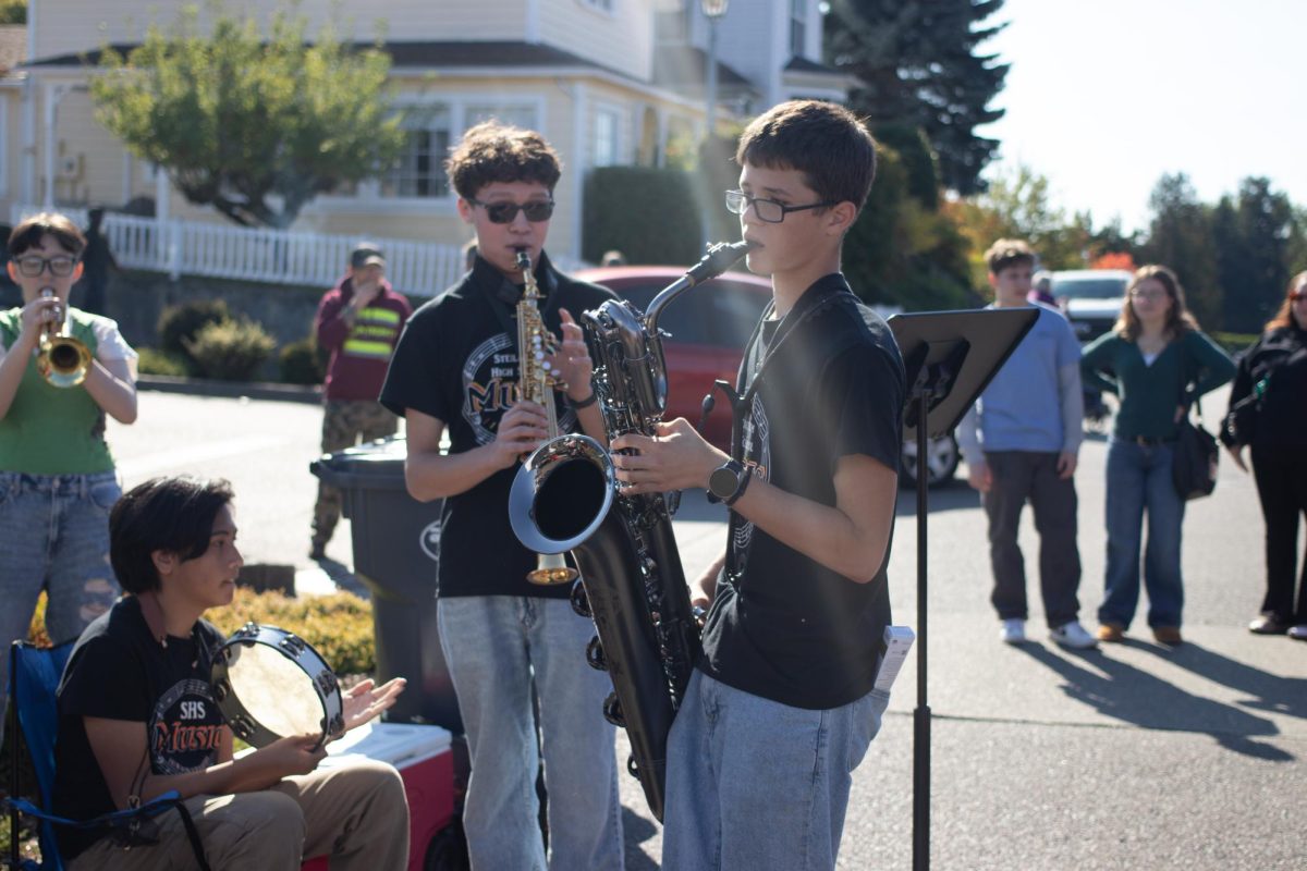 Members of the high school band improving on the street for the apple squeez.